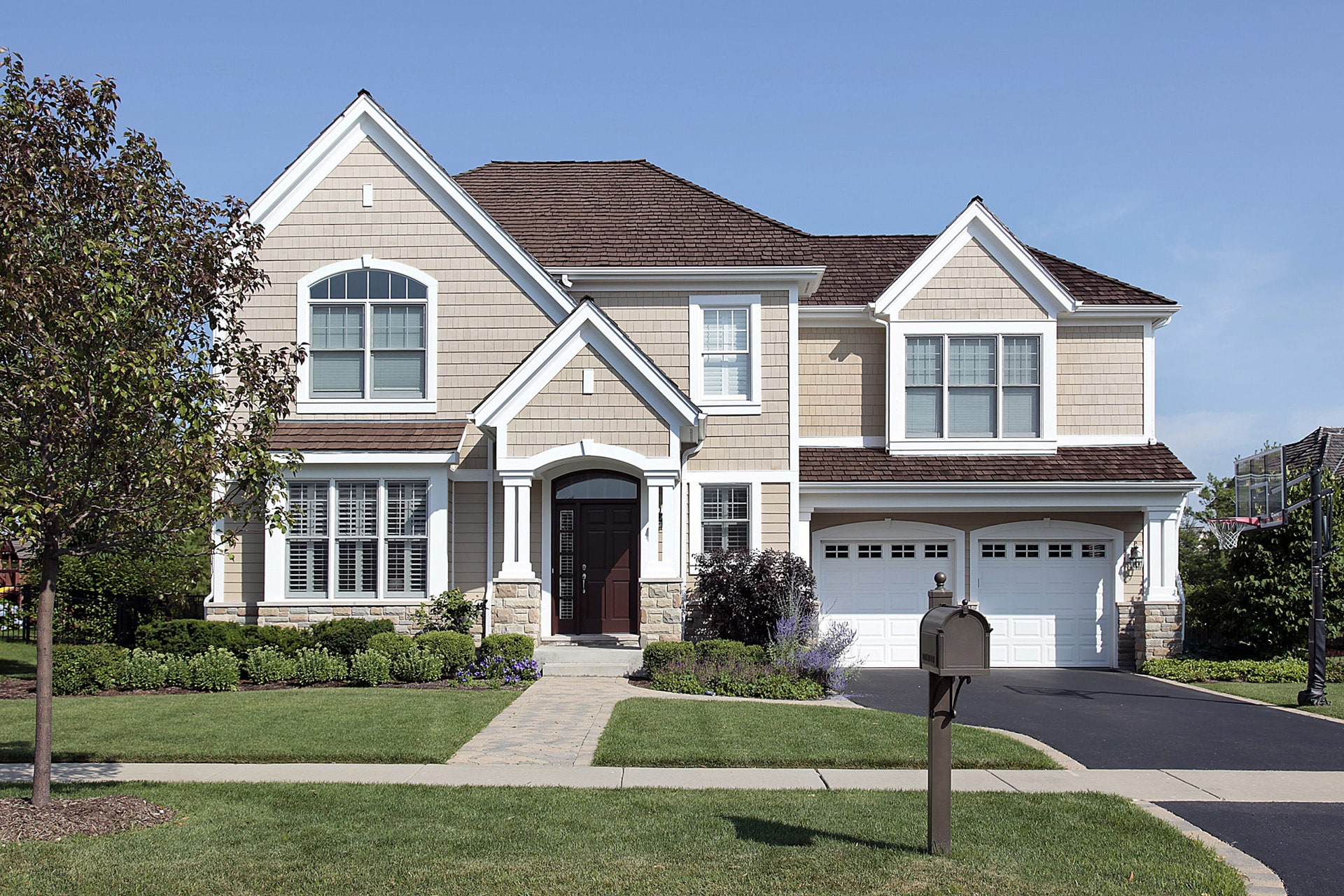 Home with brown cedar roof and custom shaped windows.