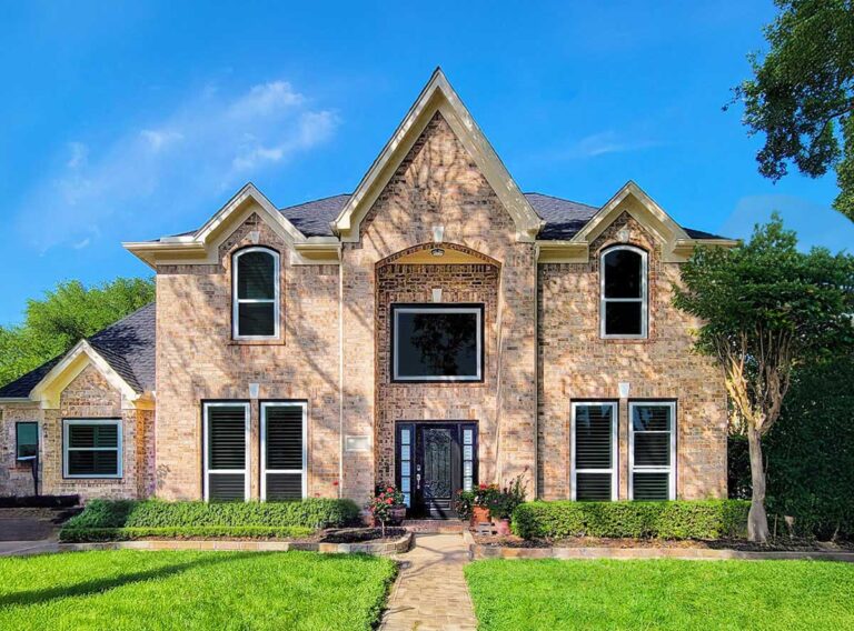 Two-story light brick home exterior